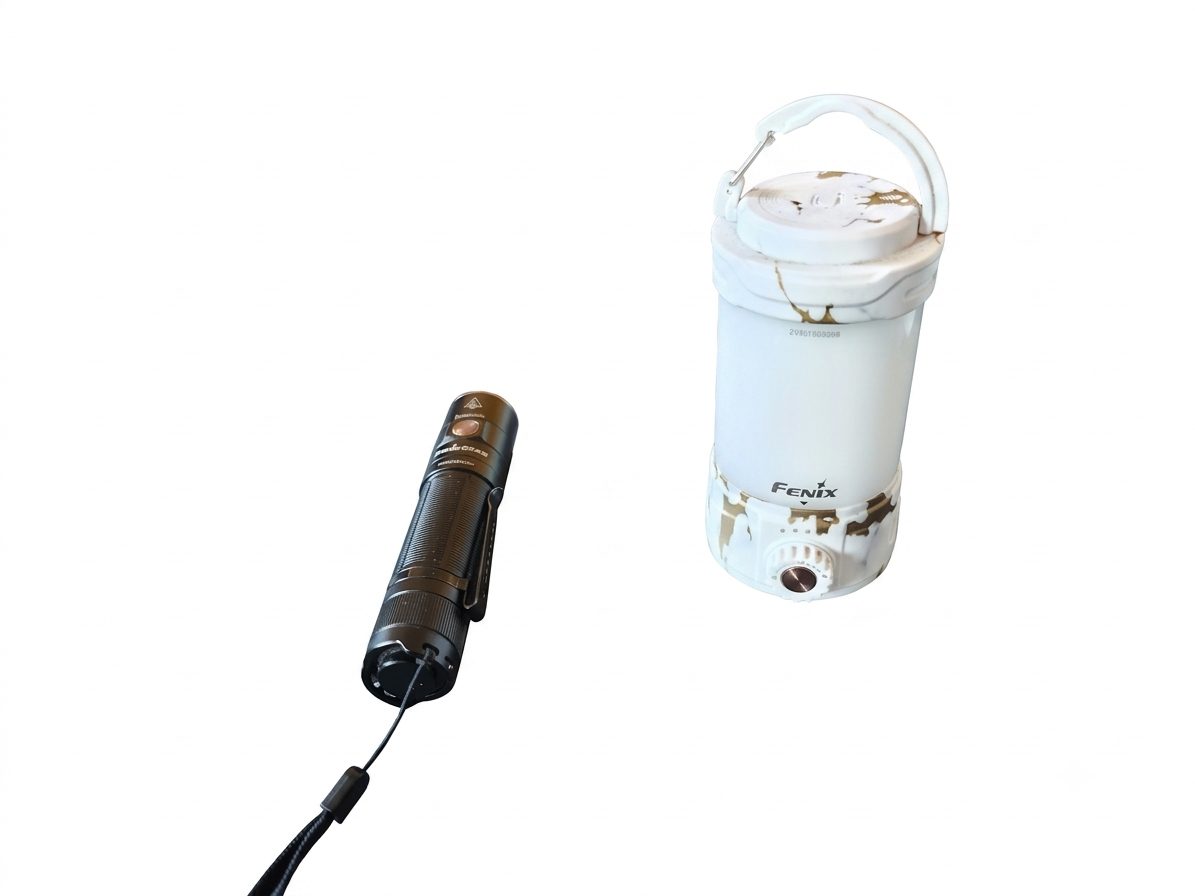 My two Fenix lights side by side: the black E35R torch with its lanyard, and the white marble CL26R Pro lantern with its hook up.