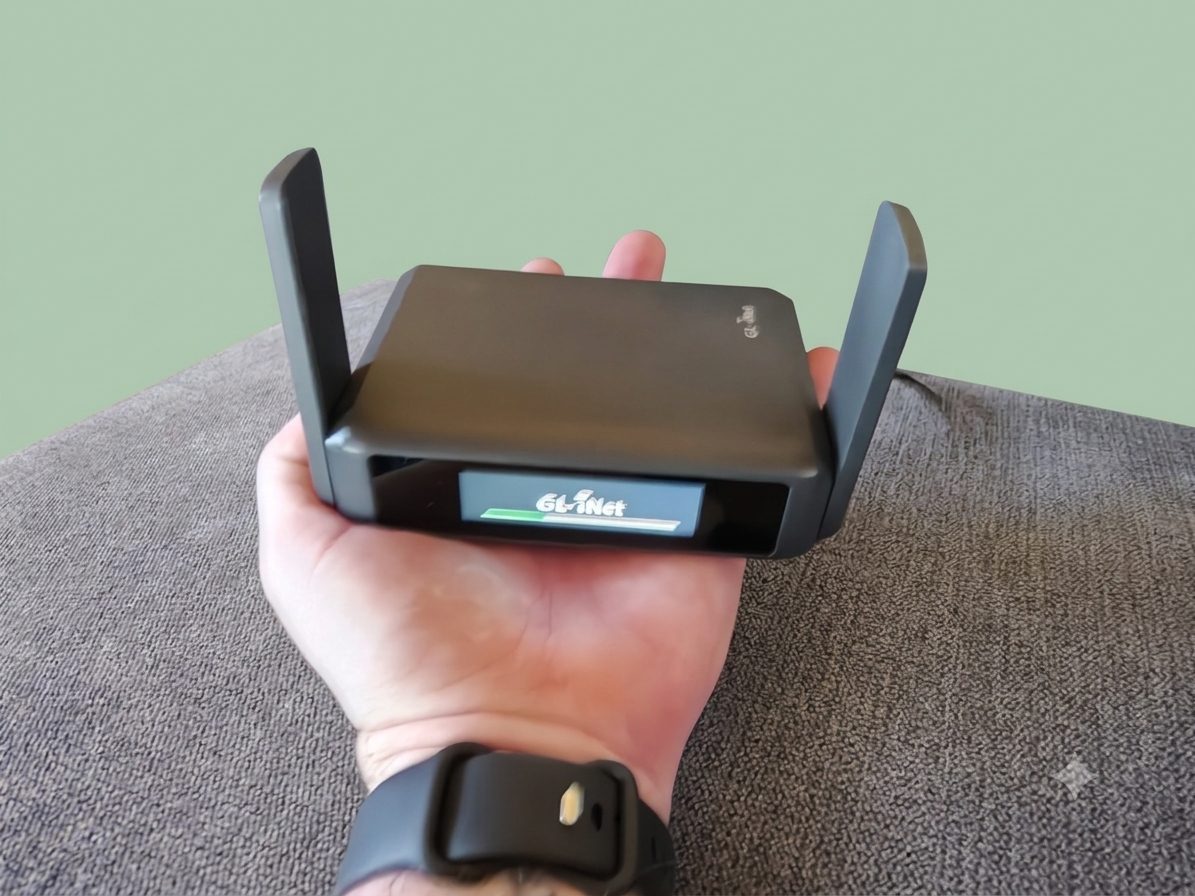 The GL.iNet Slate 7 held in the palm of my hand, showing how small it is.